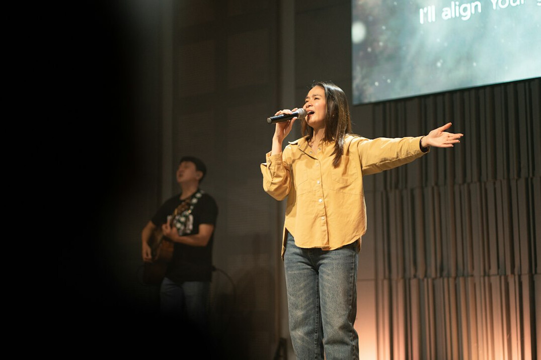 woman speaking confidently on stage