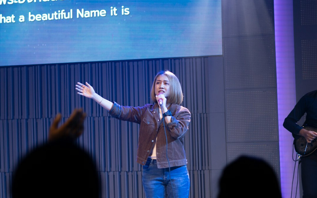 woman speaking confidently on stage